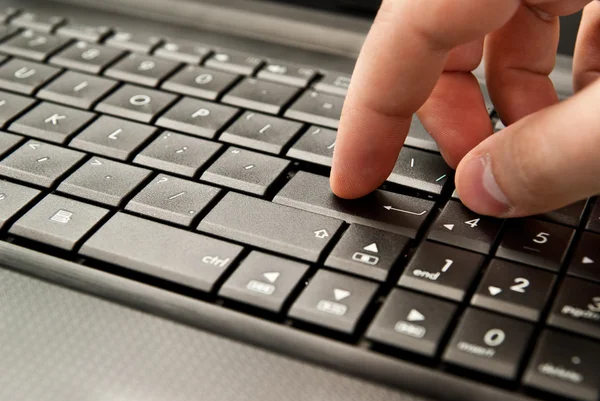 Finger pressing laptop Stock Image
