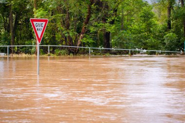 Very flooded road and give way sign clipart