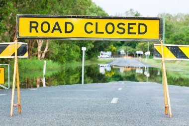 Road closed traffic sign on a flooded road clipart