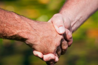 Firm handshake between two men clipart