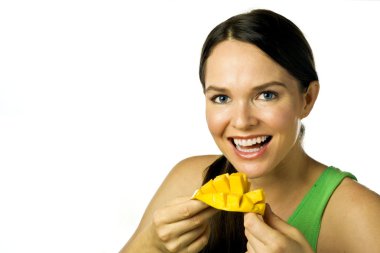 Young happy woman eating mango over white clipart