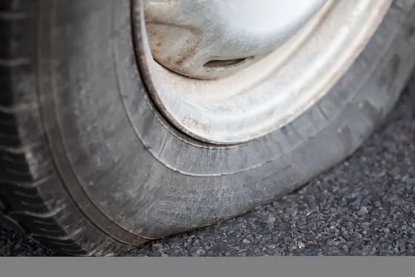 Closeup of a flat tire — Stock Photo, Image