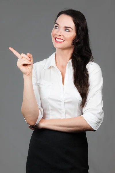 Business woman pointing at copyspace — 图库照片