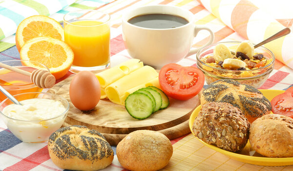 Breakfast including rolls, egg, cheese, coffee and orange juice
