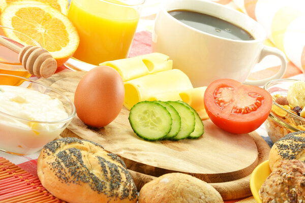 Breakfast including rolls, egg, cheese, coffee and orange juice