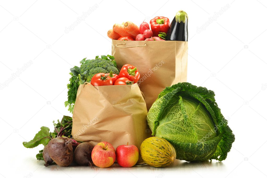 Raw vegetables and shopping bag isolated on white
