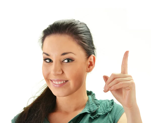 Νεαρή γυναίκα χαμογελώντας με το δάχτυλό του επάνω απομονωθεί σε λευκό — Φωτογραφία Αρχείου