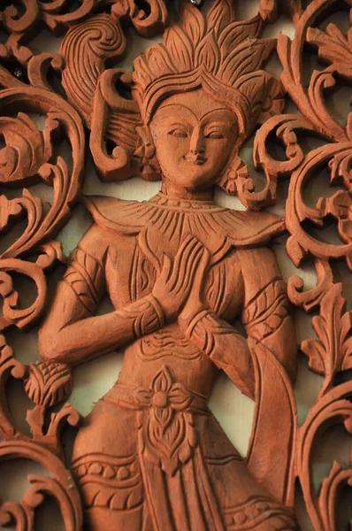 Thai art woman deity wood craving in thai temple — Stock Photo, Image
