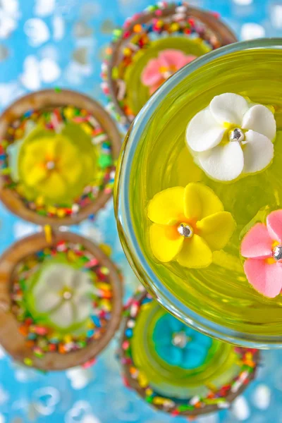 stock image Sugar flowers in a glass with a yellow jelly