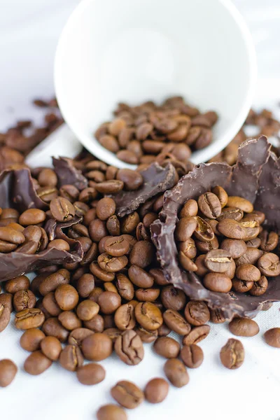White cup with coffee beans — Stock Photo, Image