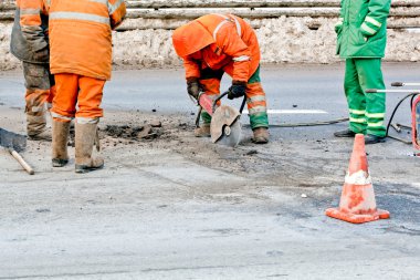 Upgrading road surfaces during roadworks clipart