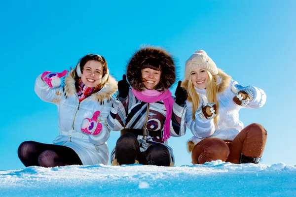 Drei fröhliche Mädchen im Winter draußen und zeigen den Daumen nach oben — Stockfoto