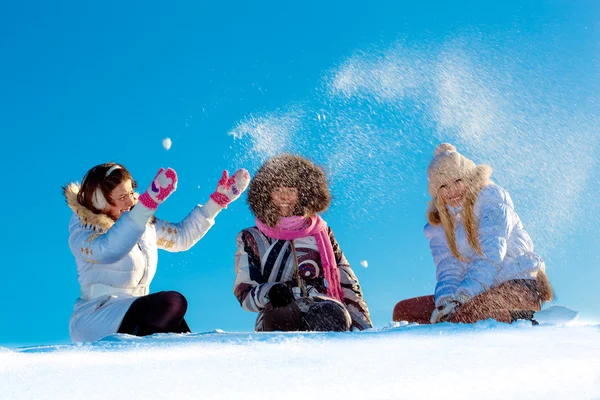 Happy cheerful girls playing with snow — Stock Photo, Image