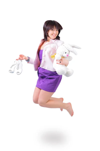 Young beautiful woman jumping in joy with plush rabbit and white shoes — Stock Photo, Image