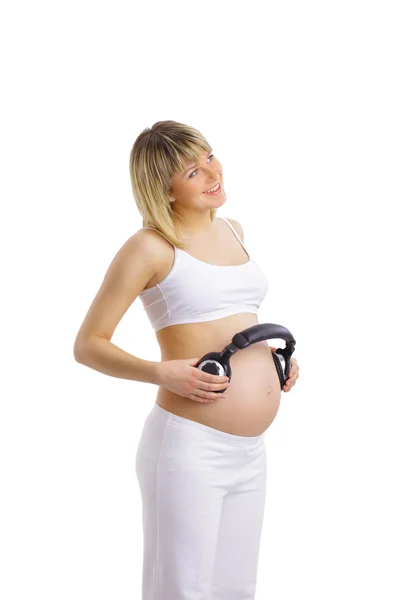 一名孕妇腹部的耳机 — 图库照片