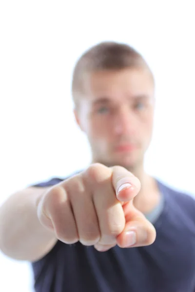 Porträt eines jungen Mannes, der mit dem Finger auf einen weißen Hintergrund zeigt — Stockfoto