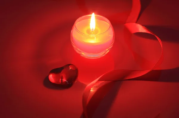 Valentýna svíčka na červeném pozadí — Stock fotografie