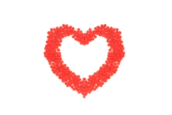 Heart made of red beads, isolated on red background. — Stock Photo, Image