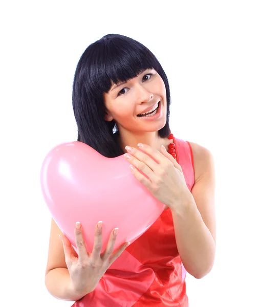 Attractive smiling woman isolated on white with heart balloon — Stock Photo, Image