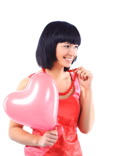 Ελκυστική χαμογελαστό γυναίκα που απομονώνονται σε λευκό με μπαλόνι καρδιά — Φωτογραφία Αρχείου