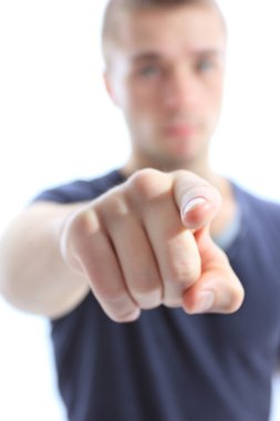 Portrait of a handsome young man pointing finger at you against white background clipart