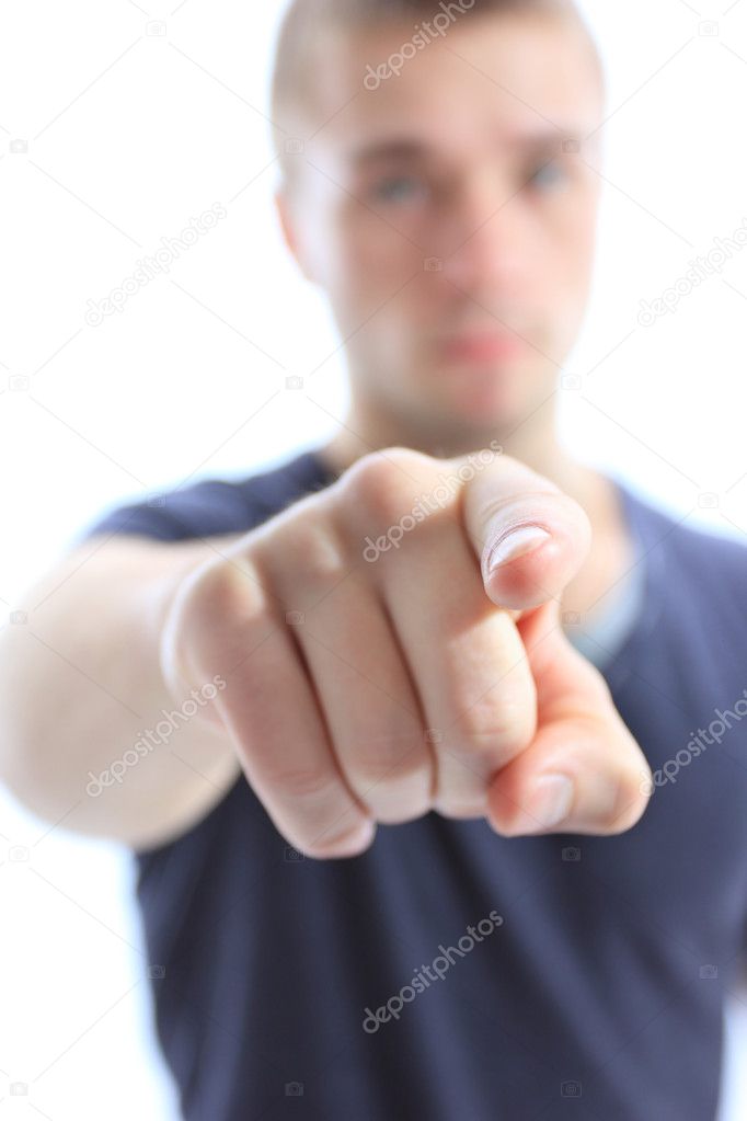 Portrait of a handsome young man pointing finger at you against white background