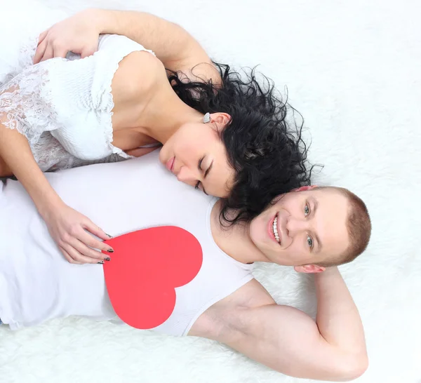 stock image Couple holding red heart together lying on the floor