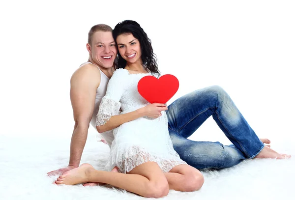 Beautiful young love couple sitting on the floor — Stock Photo, Image