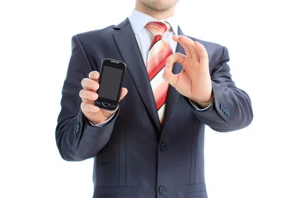 Ο άνθρωπος των επιχειρήσεων δείχνει εντάξει σημάδι με το κινητό του τηλέφωνο — Φωτογραφία Αρχείου