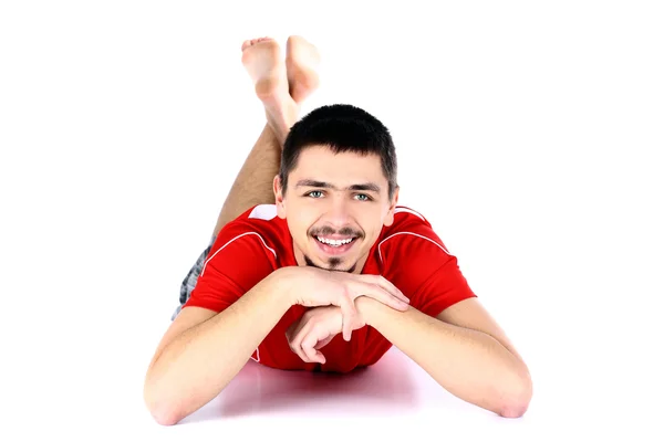 Mann auf dem Boden liegend, Gesicht auf Hände gestützt — Stockfoto