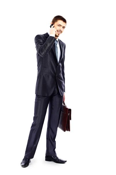 Full length portrait of a young businessman talking on the mobile phone — Stock Photo, Image