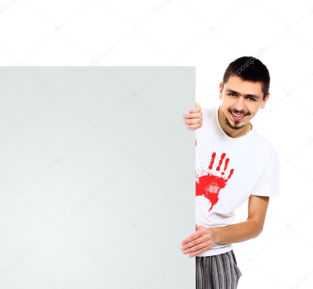 Happy handsome man showing look out from white blank banner