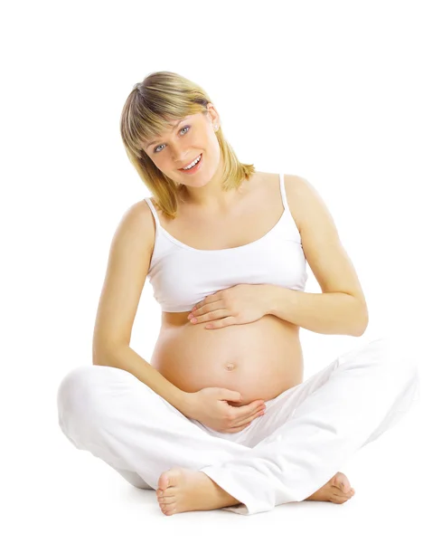 Gravid kvinna sitta och öva yoga isolerad på vit — Stockfoto