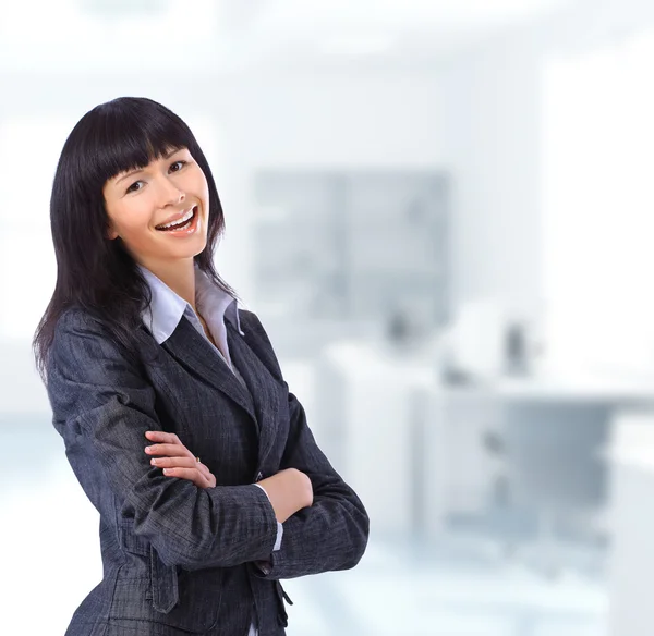 Young brunette business woman in her office — Stock Photo, Image