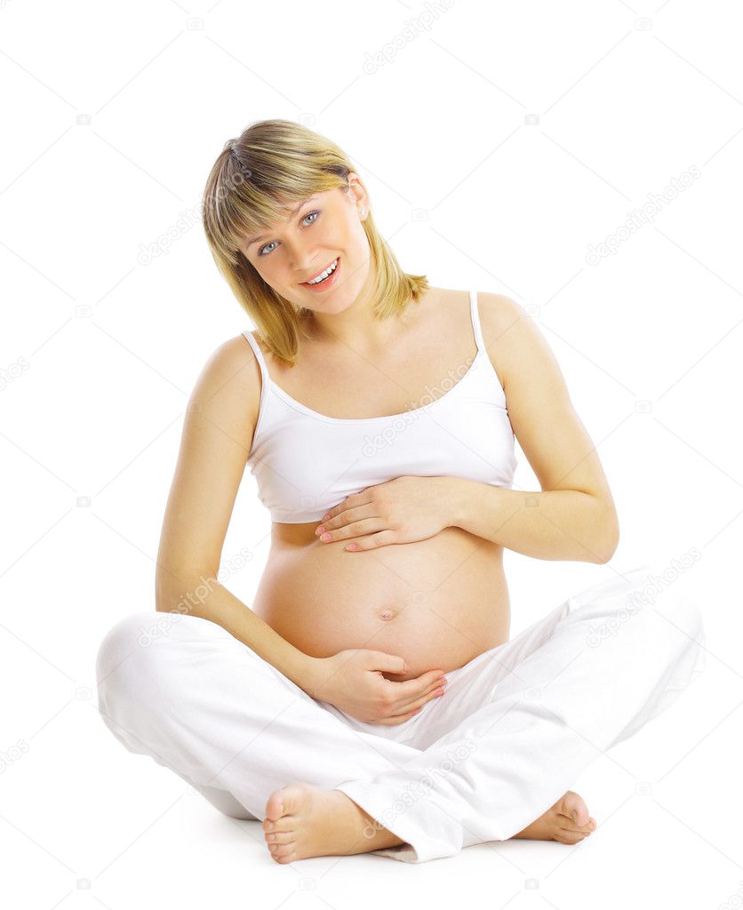 Pregnant woman sitting and practicing yoga isolated on white