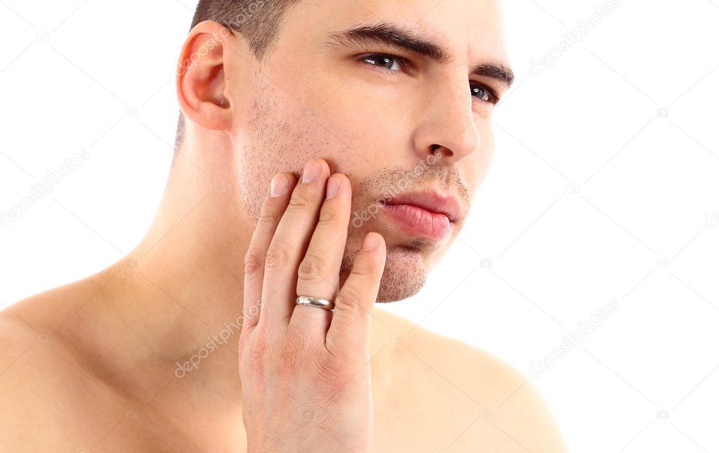 Close-up of young man applying shaving cream isolated