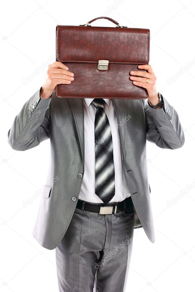 Bisinessman who is afraid of anything and covering his face of the business briefcase