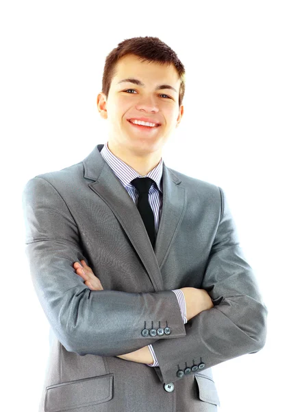 Smiling young businessman standing against isolated — Stock Photo, Image
