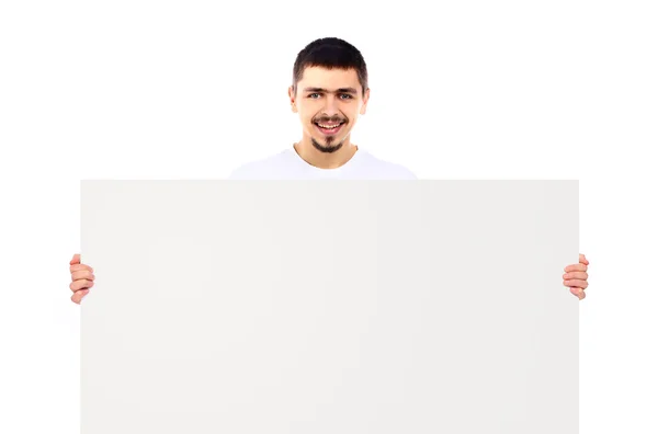 Porträtt av en ung man som visar en tom billboard på vit bakgrund — Stockfoto