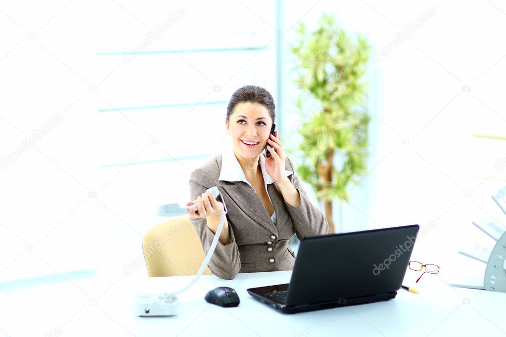 Portrait of happy business woman on phone call at office