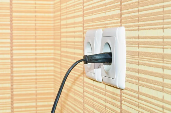 Power plug into the socket on the wall — Stock Photo, Image