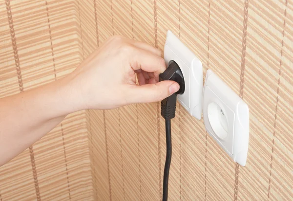 Hand insert the plug into the power