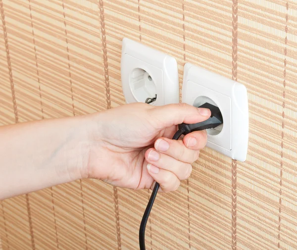 Hand insert the plug into the power — Stock Photo, Image