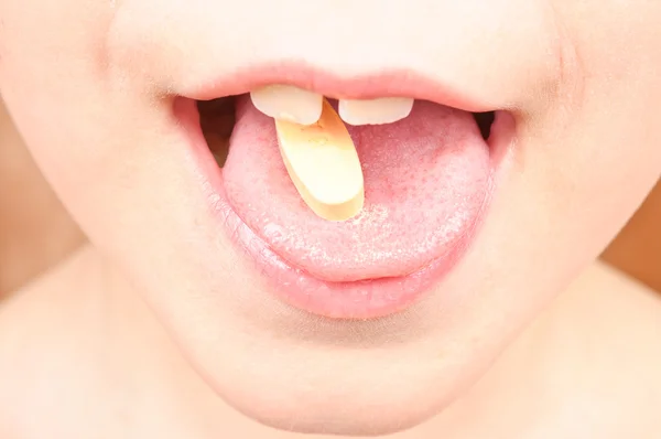 Barnet sätter p-piller i munnen — Stockfoto