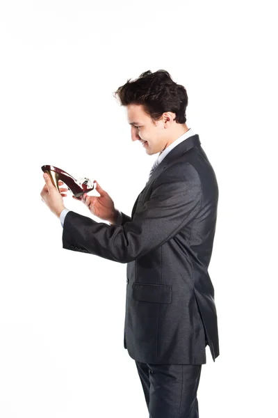 Young businessman with hands in the women's shoes — Stock Photo, Image