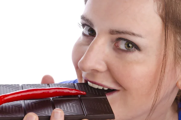 Woman with red paprika and chocolate — Stock Photo, Image