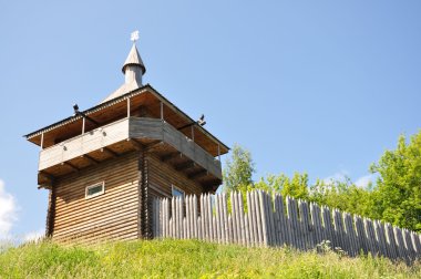 Modern reconstruction of the watchtower and wooden ramparts of the fortress clipart