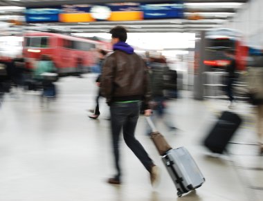 Passenger man walking with a bag at the raolway station near train clipart