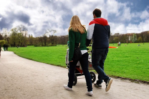 stock image Family walking in the park road