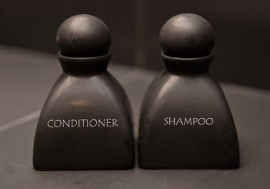 Black bottle of shampoo and conditioner clipart